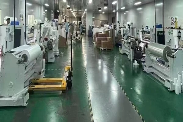 DTF film slitting production workshop with coating and rewinding machines for film manufacturing process